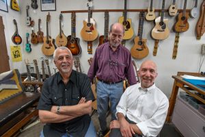 Saul Rosenthal (L) and Claude Brachfeld (R) pose for a photo August 12, 2016. They are buying the Denver Folklore Center from Harry Tuft (standing). (Photo By John Leyba/The Denver Post)